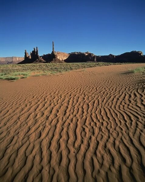 Sand ripples and rock formations in Monument Valley