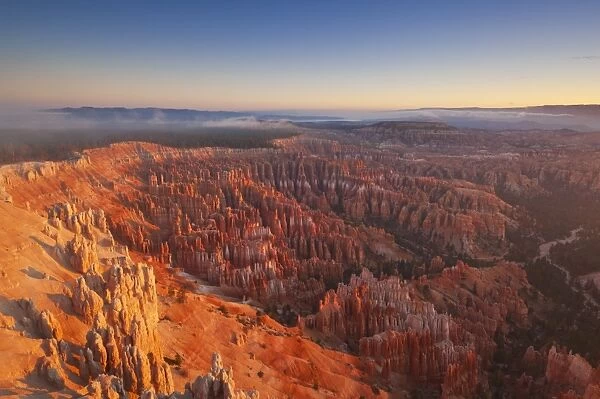 Sandstone hoodoos in Bryce Amphitheater, sunrise with low mist, Bryce Canyon National Park