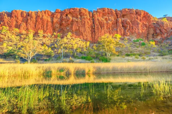 Framed Print : Scenic red sandstone wall and bush vegetation reflected in waterhole, Glen Helen Gorge Framed Print : Scenic red sandstone wall and bush vegetation reflected in waterhole, Glen Helen Gorge