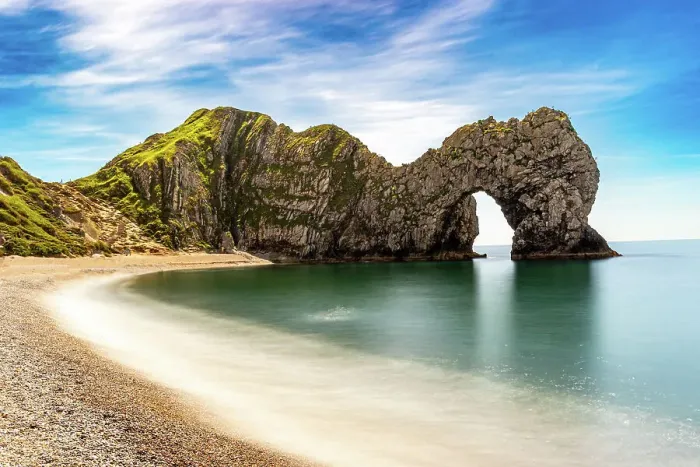 Framed Print : Scenic view of a natural arch on a coastline with a sandy beach and clear blue sky at Durdle Door, Jurassic Coast, UNESCO World Heritage Site, Dorset, England, United Kingdom, Europe Framed Print : Scenic view of a natural arch on a coastline with a sandy beach and clear blue sky at Durdle Door, Jurassic Coast, UNESCO World Heritage Site, Dorset, England, United Kingdom, Europe