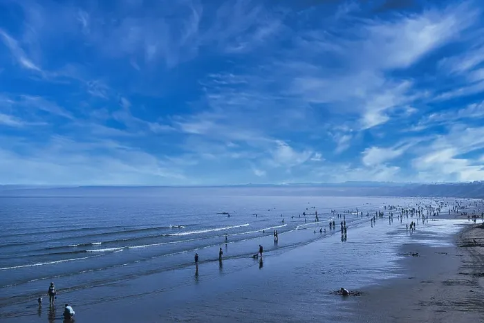 Framed Print : Scenic view of a tranquil beach with people strolling and the vast ocean meeting a blue sky with wispy clouds in Filey, England Framed Print : Scenic view of a tranquil beach with people strolling and the vast ocean meeting a blue sky with wispy clouds in Filey, England