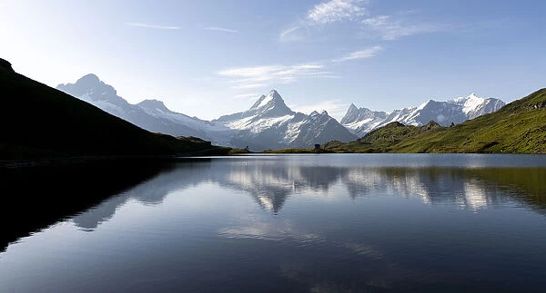 Schreckhorn mountain reflected in Bachalpsee lake at dawn, Grindelwald, Bernese Oberland