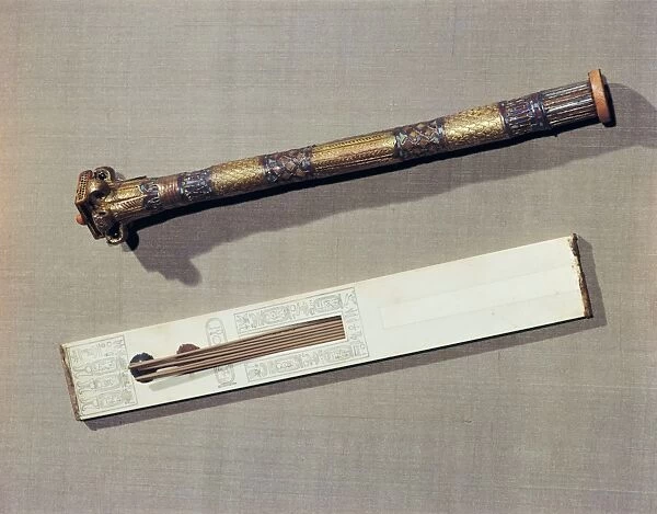 A scribes palette in ivory and a case for writing-reeds made of wood plated with gold