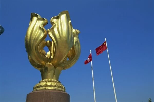Sculpture and the Chinese flags flying at the Hong Kong Convention and Exhibition Centre