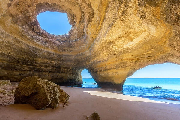 The sea caves of Benagil with natural windows on the clear waters of the Atlantic Ocean
