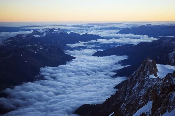 Sea of clouds below Aiguille du Midi cable car station, Mont Blanc range