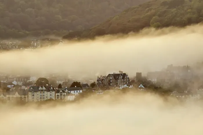 Framed Print : Sea fog envelops the coastal town of Lynton, lit by the light of sunset, seen from Countisbury Hill, Exmoor National Park, Devon, England, United Kingdom, Europe Framed Print : Sea fog envelops the coastal town of Lynton, lit by the light of sunset, seen from Countisbury Hill, Exmoor National Park, Devon, England, United Kingdom, Europe