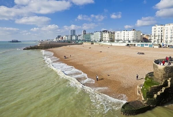 The seafront with people on the beach at Brighton Beach, East Sussex, England, United Kingdom, Europe
