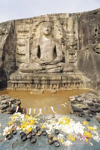 Seated Buddha statue with offerings