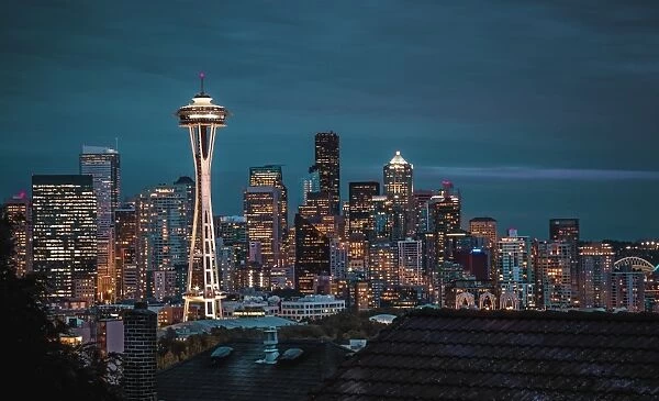 Seattle city skyline at night with urban office buildings and Space Needle viewed