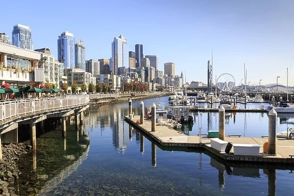 Seattle Skyline and restaurants on sunny day in Bell Harbor Marina, Seattle, Washington State