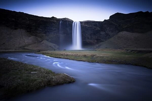 Seljalandsfoss Waterfall captured at dusk using long exposure to record movement in the water