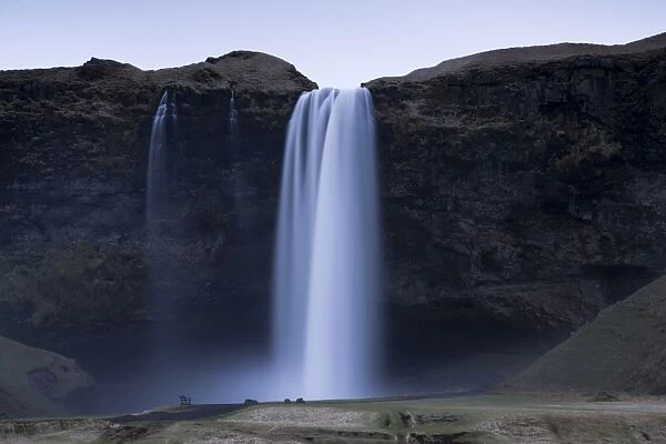 Seljalandsfoss Waterfall captured at dusk using long exposure to record movement in the water