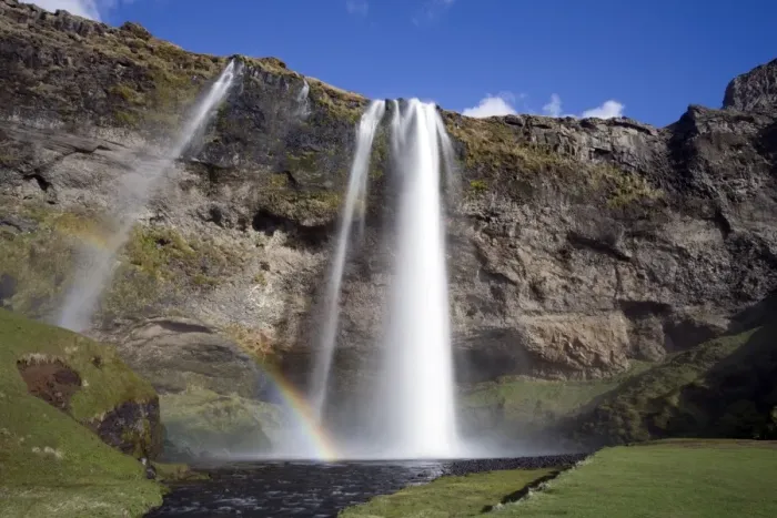 Framed Print : Seljalandsfoss Waterfall tumbling over towering cliffs in bright sunlight with rainbow at the base of the waterfall, near Hella, Southern Iceland, Iceland Framed Print : Seljalandsfoss Waterfall tumbling over towering cliffs in bright sunlight with rainbow at the base of the waterfall, near Hella, Southern Iceland, Iceland