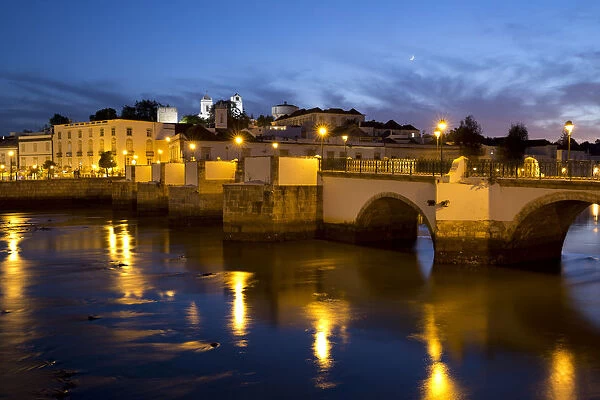 Seven arched Roman bridge and town on the Rio Gilao river at night, Tavira, Algarve