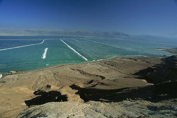 The shallow south end of the Dead Sea where salt deposits left by massive evaporation are mined