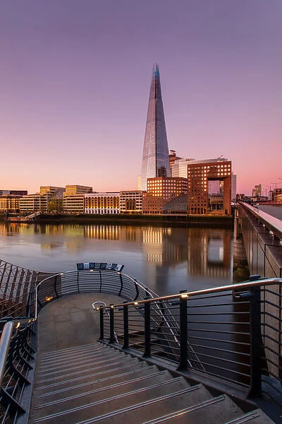 The Shard and London Bridge at sunrise with reflections on the River Thames, London