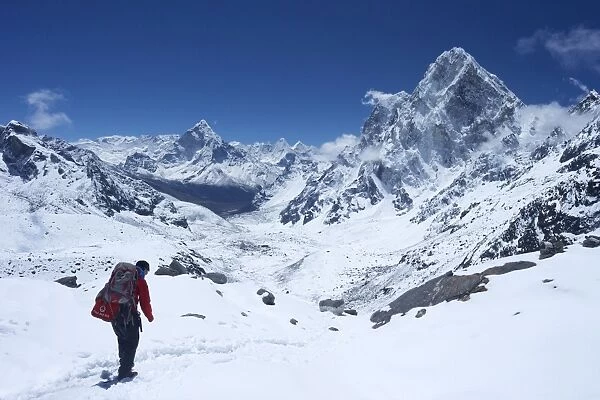 Sherpa guide walking over Cho La Pass with Ama Dablam on left and Arakam Tse on right side, Solukhumbu District, Nepal, Himalayas, Asia