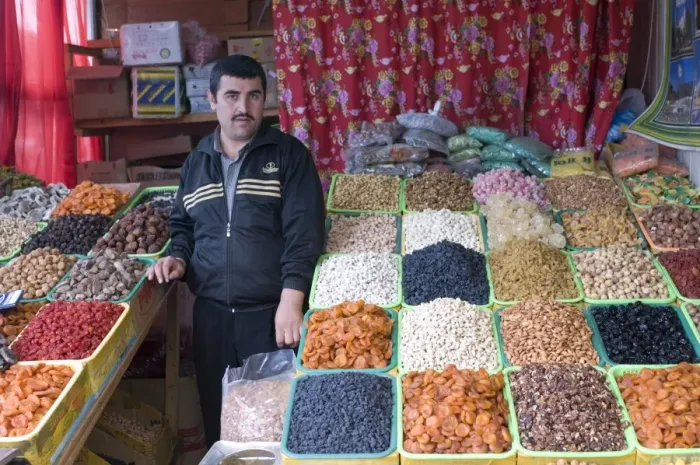 Framed Print : Shopseller in the bazaar selling dried fruits, Almaty, Kazakhstan, Central Asia, Asia