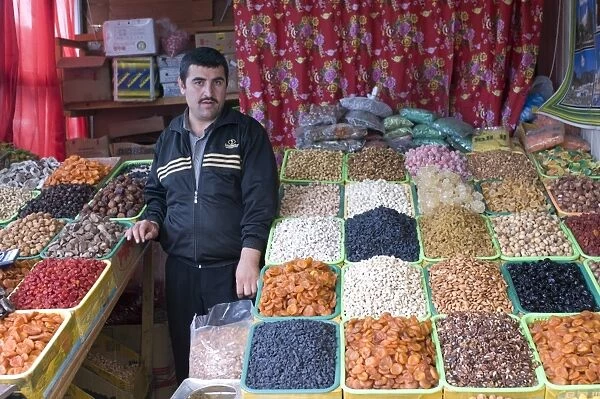 Shopseller in the bazaar selling dried fruits, Almaty, Kazakhstan, Central Asia, Asia