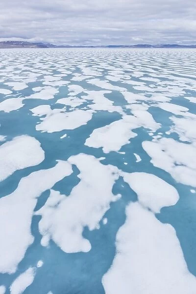 Shorefast ice starting to melt in Maxwell Bay, Devon Island, Nunavut, Canada