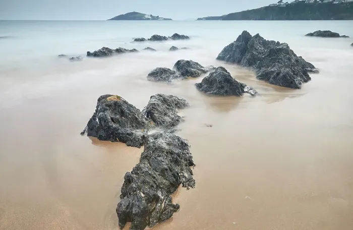 Framed Print : Shoreline boulders buried in sand face an advancing tide at dusk, looking from Bantham beach towards Burgh Island, on the south coast of Devon, England, United Kingdom, Europe Framed Print : Shoreline boulders buried in sand face an advancing tide at dusk, looking from Bantham beach towards Burgh Island, on the south coast of Devon, England, United Kingdom, Europe