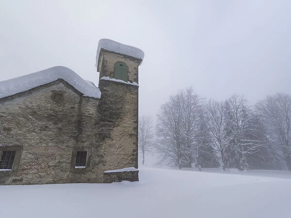 Shrine of Madonna dell Acero covered by snow, Parco Regionale del Corno alle Scale