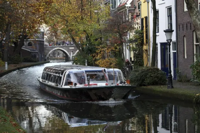 Framed Print : A sightseeing barge tours along the Oudegracht Canal in the Dutch city of Utrecht Framed Print : A sightseeing barge tours along the Oudegracht Canal in the Dutch city of Utrecht