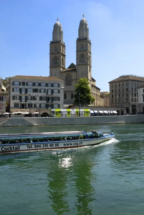 Framed Print : Sightseeing boat on the River Limmat in front of Grossmunster church Framed Print : Sightseeing boat on the River Limmat in front of Grossmunster church