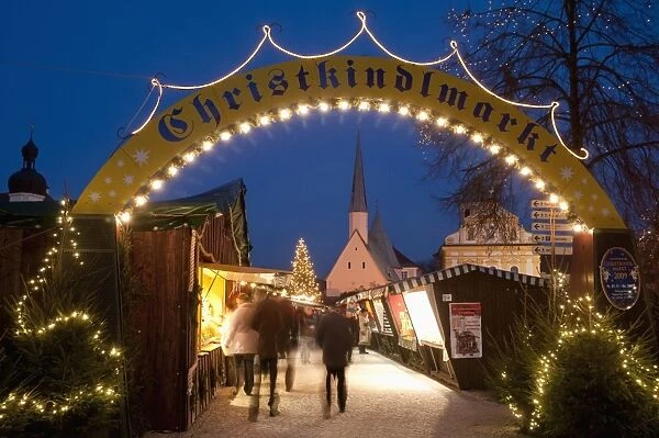 Sign over gate and stalls, Christmas Market (Christkindlmarkt) on Kapellplatz Square