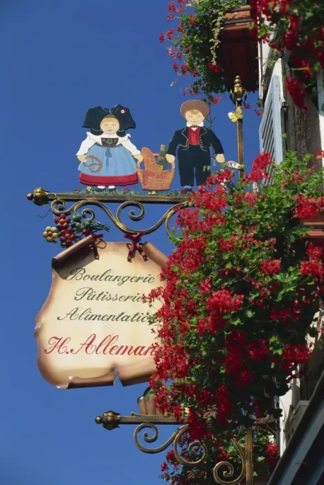 Framed Print : Sign outside traditional patisserie, red flowers prominent, Eguisheim, Haut-Rhin