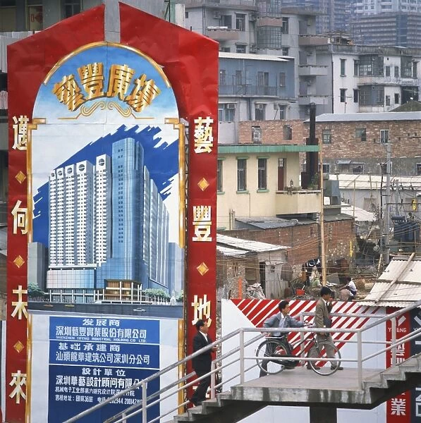 Sign showing modern buildings in front of old huts and apartment blocks in the Shenzhen Development Zone, Guangdong