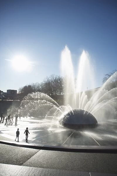 Silhouette of children playing in water fountain, Seattle Center, Seattle