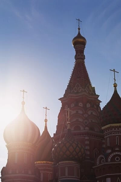 Silhouette of the onion domes of St. Basils Cathedral in Red Square, UNESCO World Heritage Site, Moscow, Russia, Europe pushed red in shadows using curves