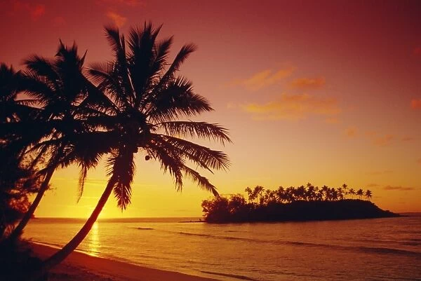 Silhouette of palm trees and desert island at sunrise, Rarotonga, Cook Islands