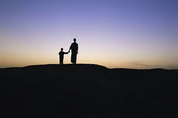Silhouette of two people at the archaeological area
