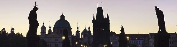Silhouette of Statues on Charles Bridge, UNESCO World Heritage Site, Dome of St. Francis Church and Old Town Bridge Tower, Prague, Bohemia, Czech Republic, Europe