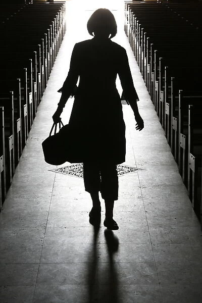 Silhouette of a woman in church