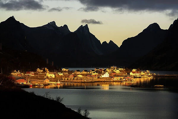 Silhouettes of mountains framing the fairy tale village along the fjord at dawn, Reine Bay, Lofoten Islands, Nordland, Norway, Scandinavia, Europe