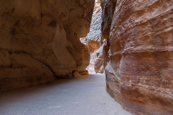 The Siq, a narrow canyon in the mountains, the entrance to the lost city of Petra, Petra, UNESCO World Heritage Site, Jordan, Middle East