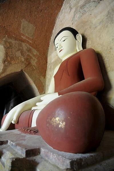 Sitting Buddha in a temple in the ruined town of Bagan, Myanmar, Asia