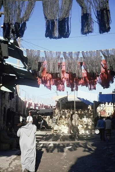 Skeins and cloth hanging in the souk