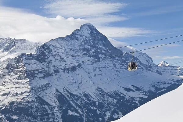 Ski gondola lift in front of the North face of the Eiger mountain, Grindelwald