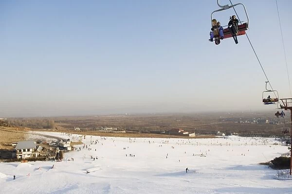 A ski lift taking skiers up to the slopes at Shijinglong ski resort, Beijing, China, Asia