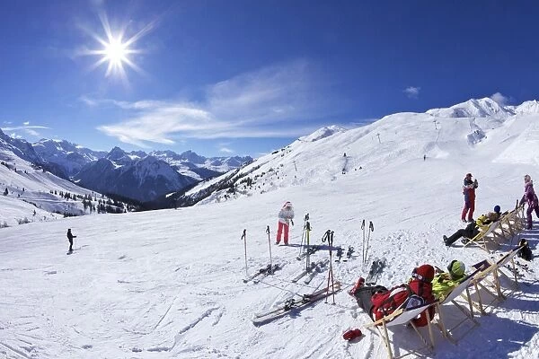 Skiers relaxing at cafe in winter sunshine, Verdons Sud, La Plagne, French Alps, France, Europe