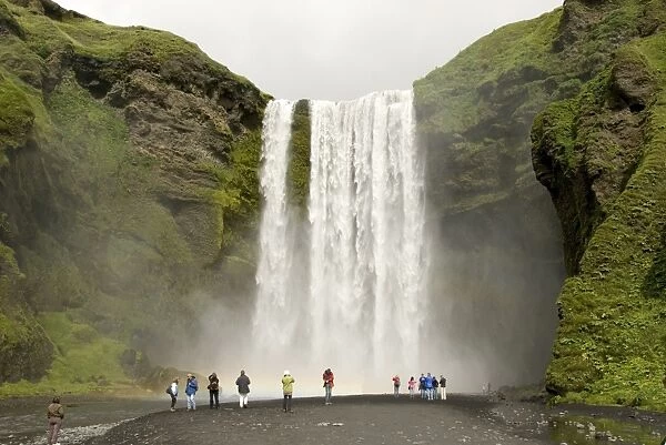 Skogarfoss, the powerful curtain waterfall drops 60 m over a cliff of basalt lavas