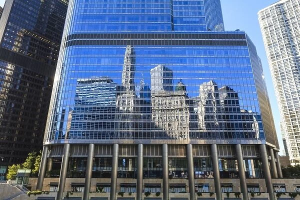 Skyscrapers on West Wacker Drive reflected in the Trump Tower, Chicago, Illinois, United States of America, North America