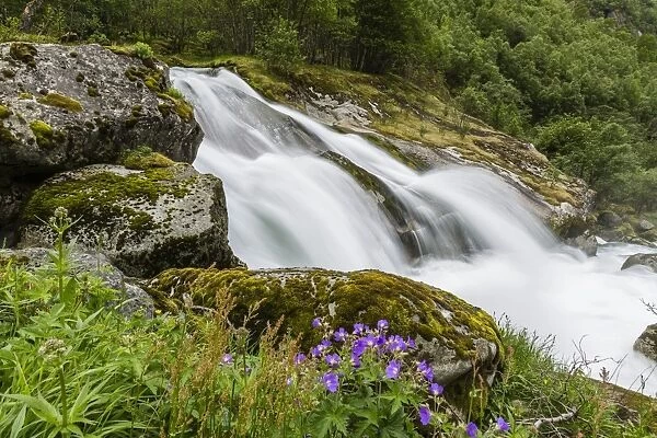 Slow shutter speed silky water of the Olden River as it flows along Briksdalen, Olden, Nordfjord, Norway, Scandinavia, Europe