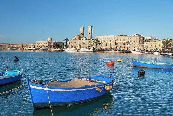 Small blue boats moored in the water of the harbour of the old medieval town of Barletta, Adriatic Sea, Mediterranean Sea, Apulia, Italy, Europe