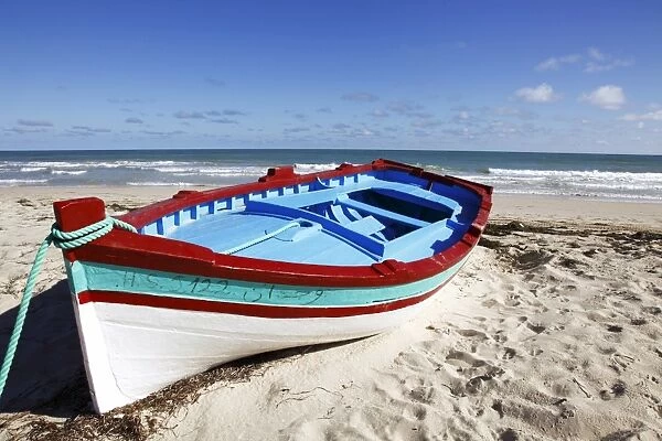 Small boat on tourist beach the Mediterranean Sea, Djerba Island, Tunisia